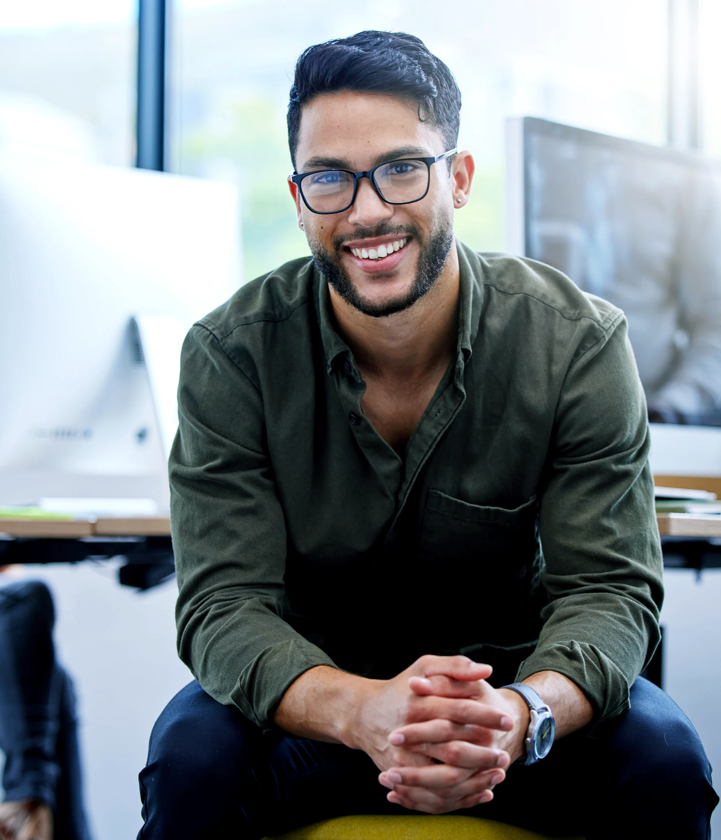 Software developer smiling to the camera.