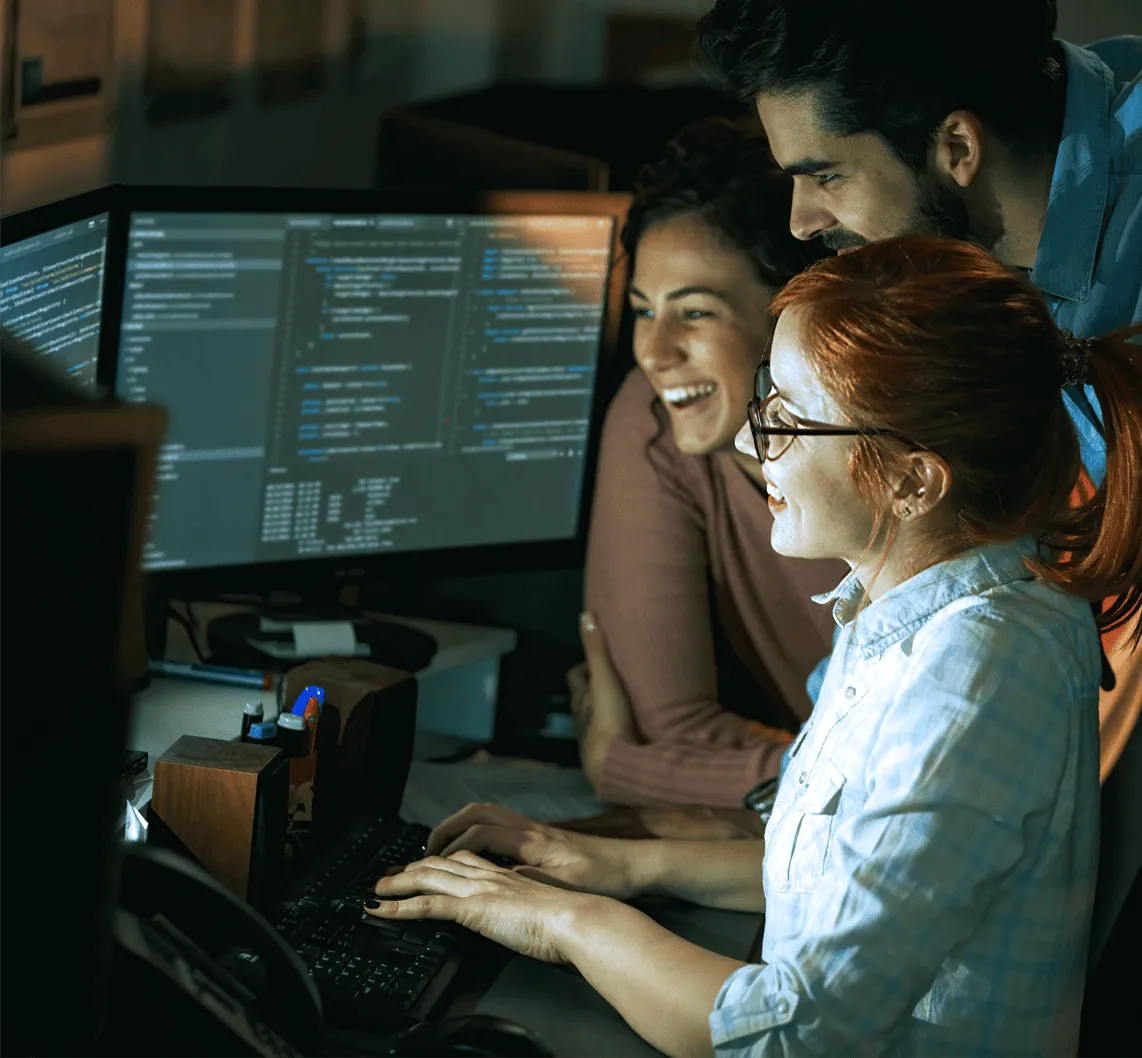A woman and a man watching how another woman works.